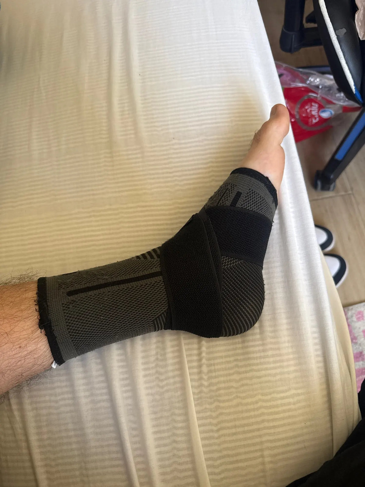 Customer photo: black arch support sleeve worn on foot